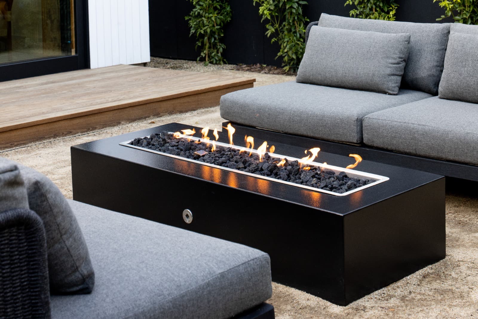 Fire pit with active flame in outdoor living space