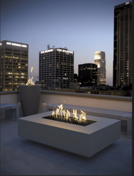 Fire feature illuminating a luxury outdoor living area at dusk