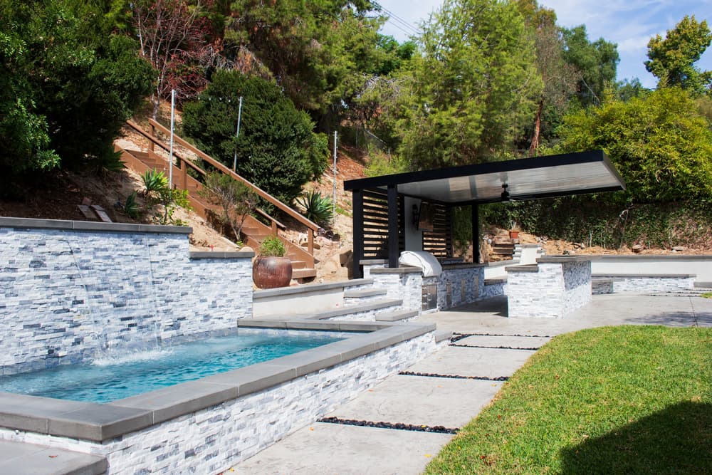 Luxury pool with water features at golden hour